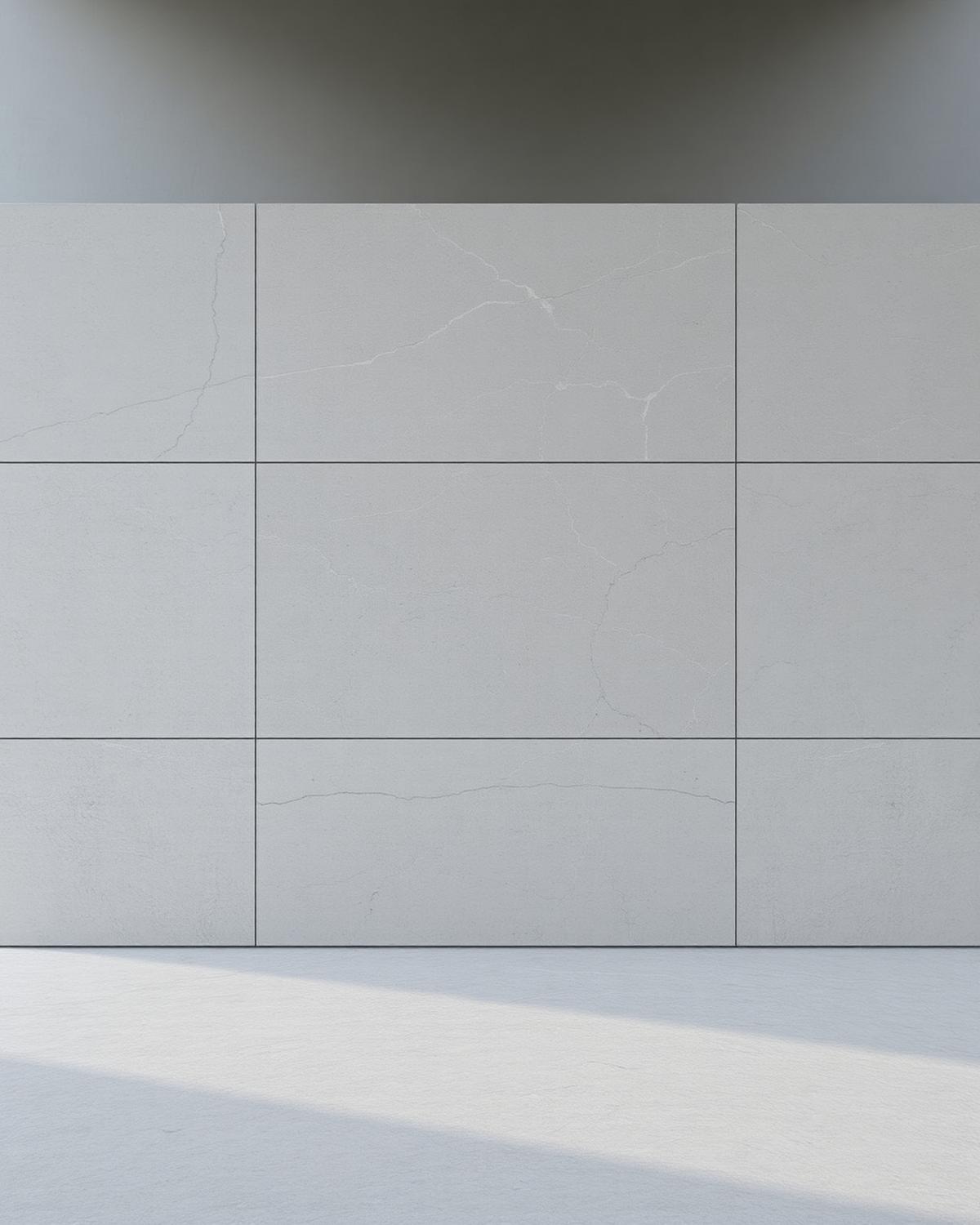 Large grey limestone slab tiles installed as continuous wall