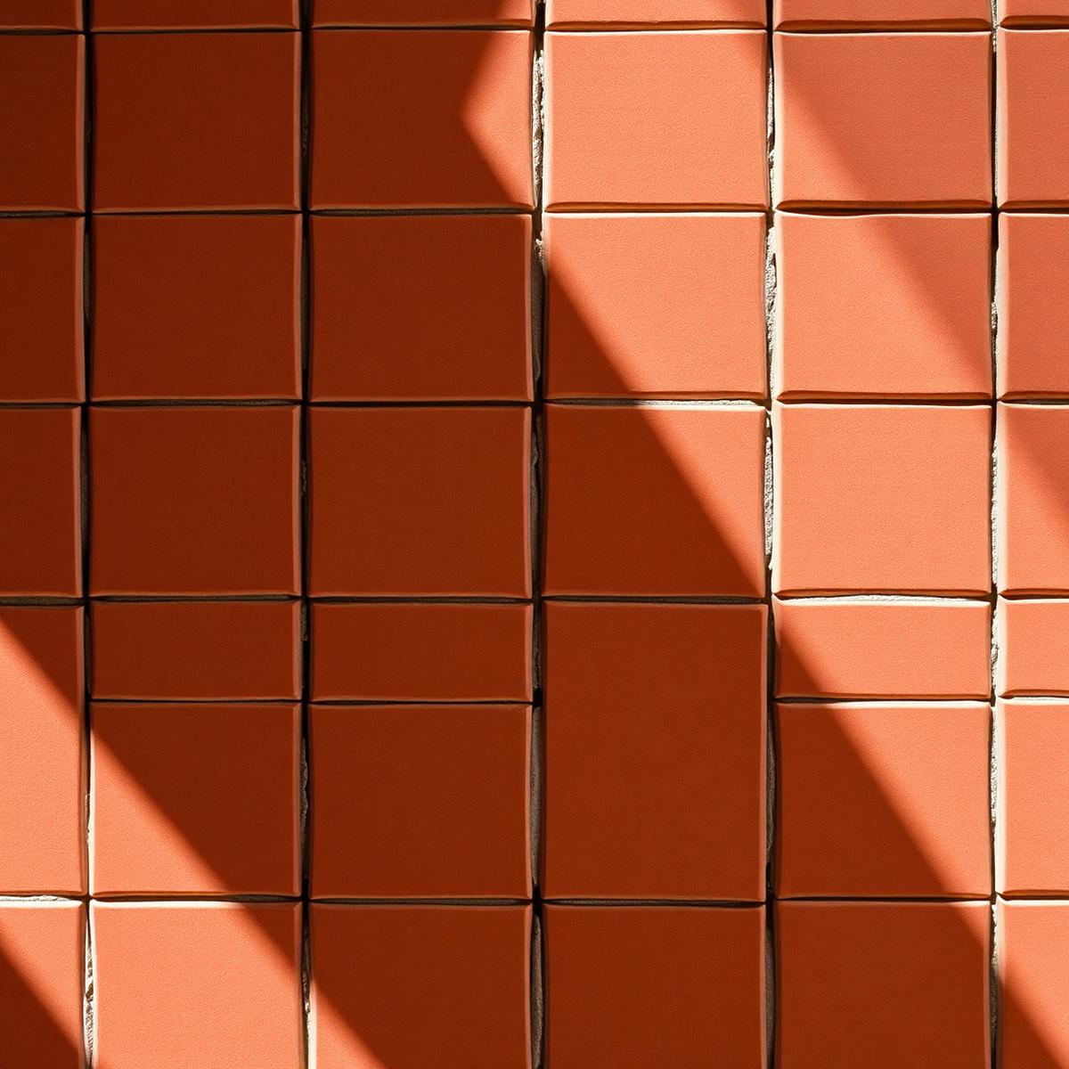 Burnt clay zellige terracotta tiles in pattern with directional sunlight